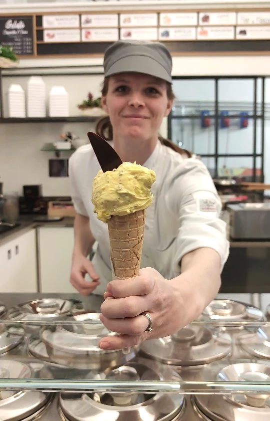 Counter of the artisanal ice cream shop DOMUS in Bergamo, with containers for decorating and filling ice creams, yogurts, and waffles. Production of artisanal ice cream with fresh and genuine products